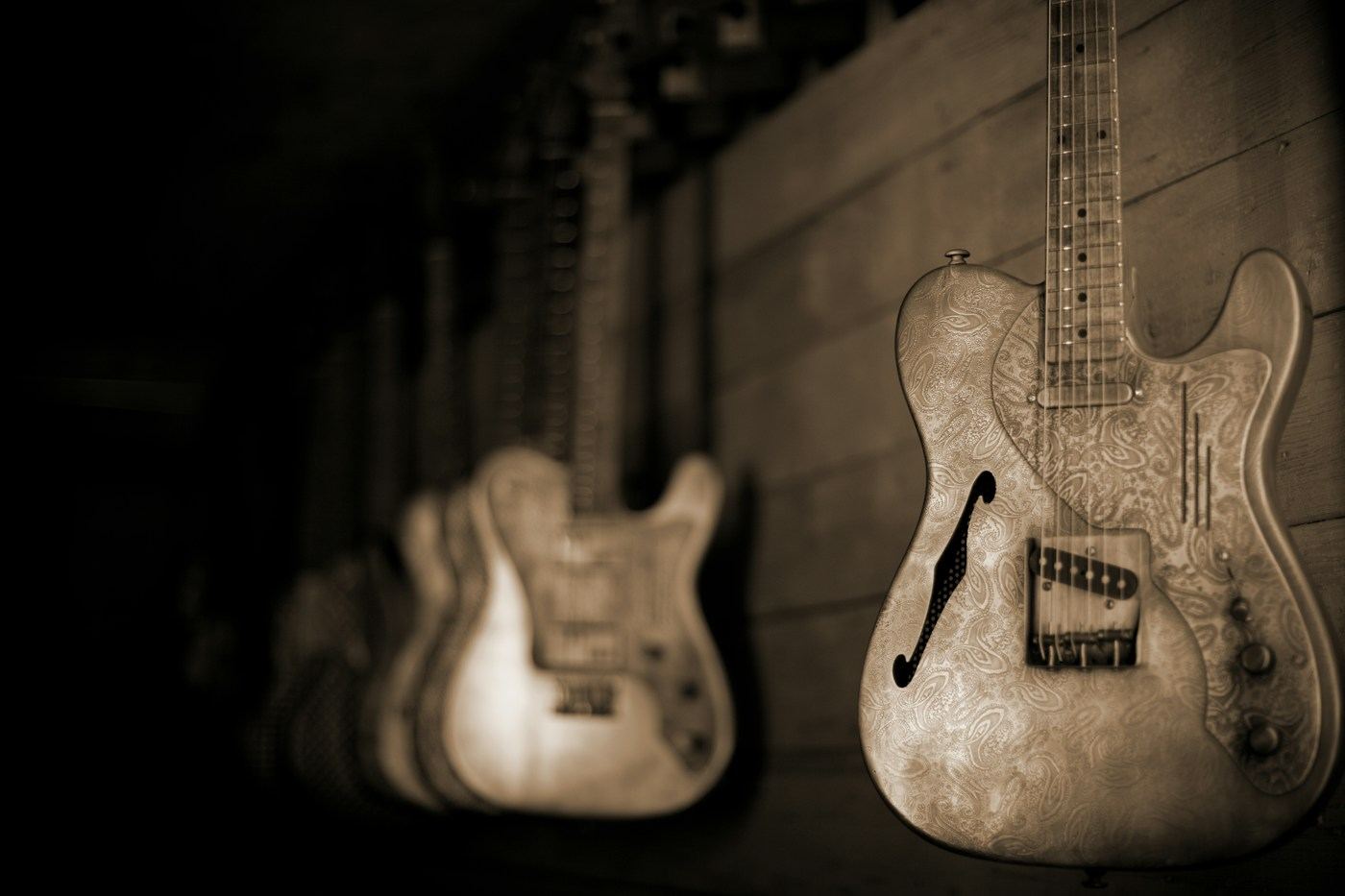 Aged custom finishes on two electric guitars